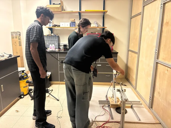 Students and a mentor working together at the propeller test stand in the laboratory.
