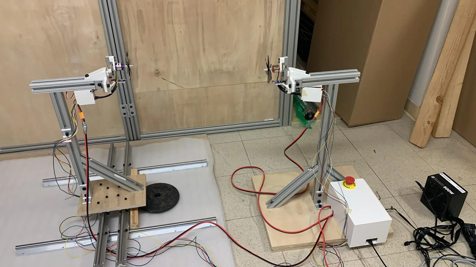 Two propeller mounts on aluminum frames with wiring and control equipment.
