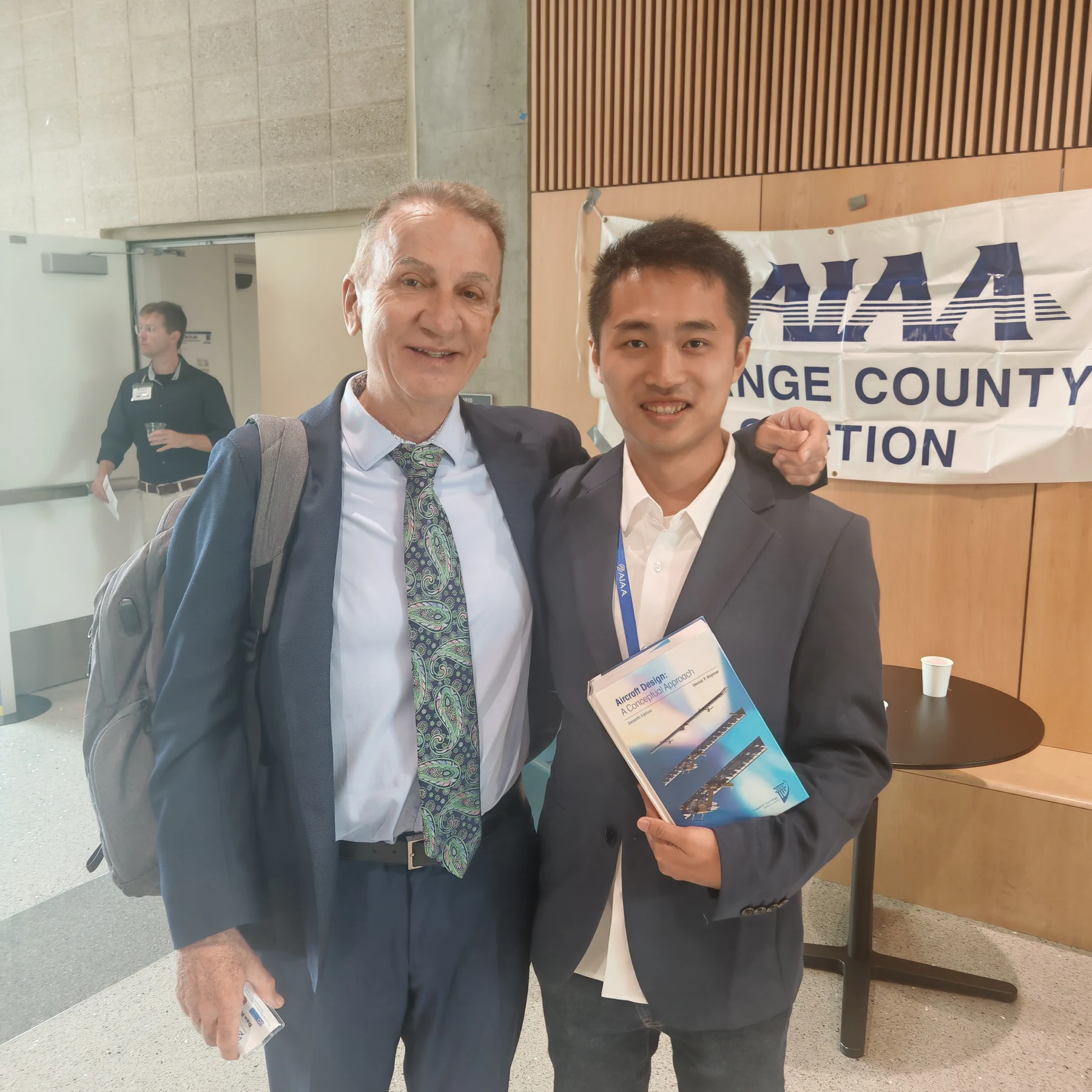 Me holding Aircraft Design and posing with its author at AIAA