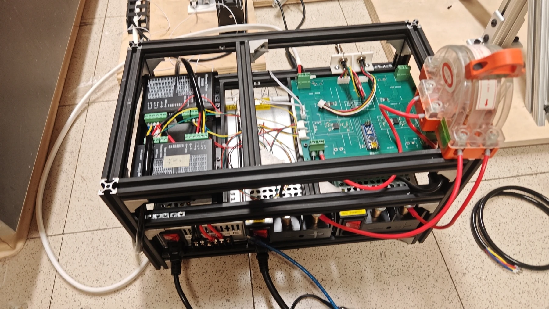 The assembled power and control unit with power supplies, motor drivers, and the main control PCB in an aluminum frame