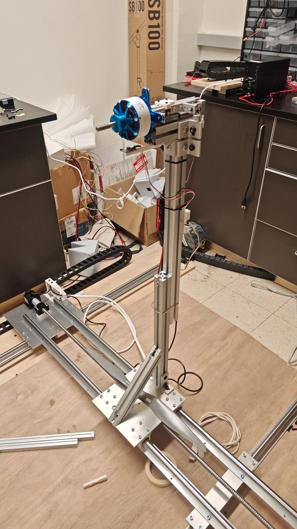 Test Stand V3 with a propeller motor, load cell mount, and motorized positioning rails