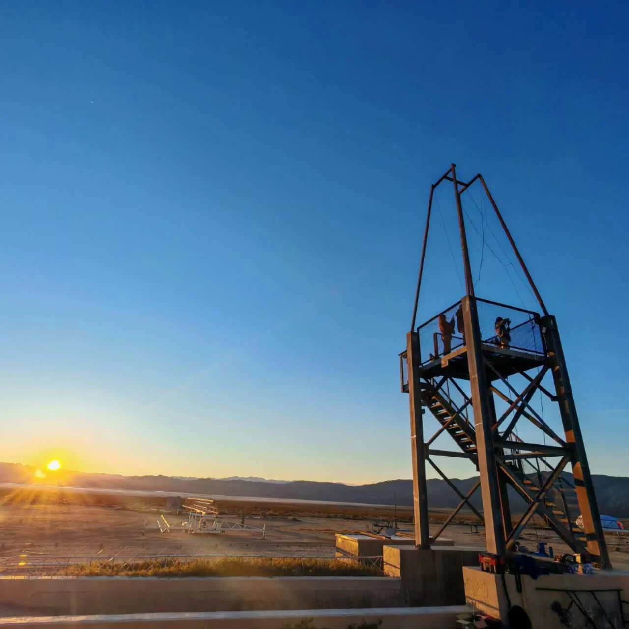 The sun setting over the desert and tower at FAR
