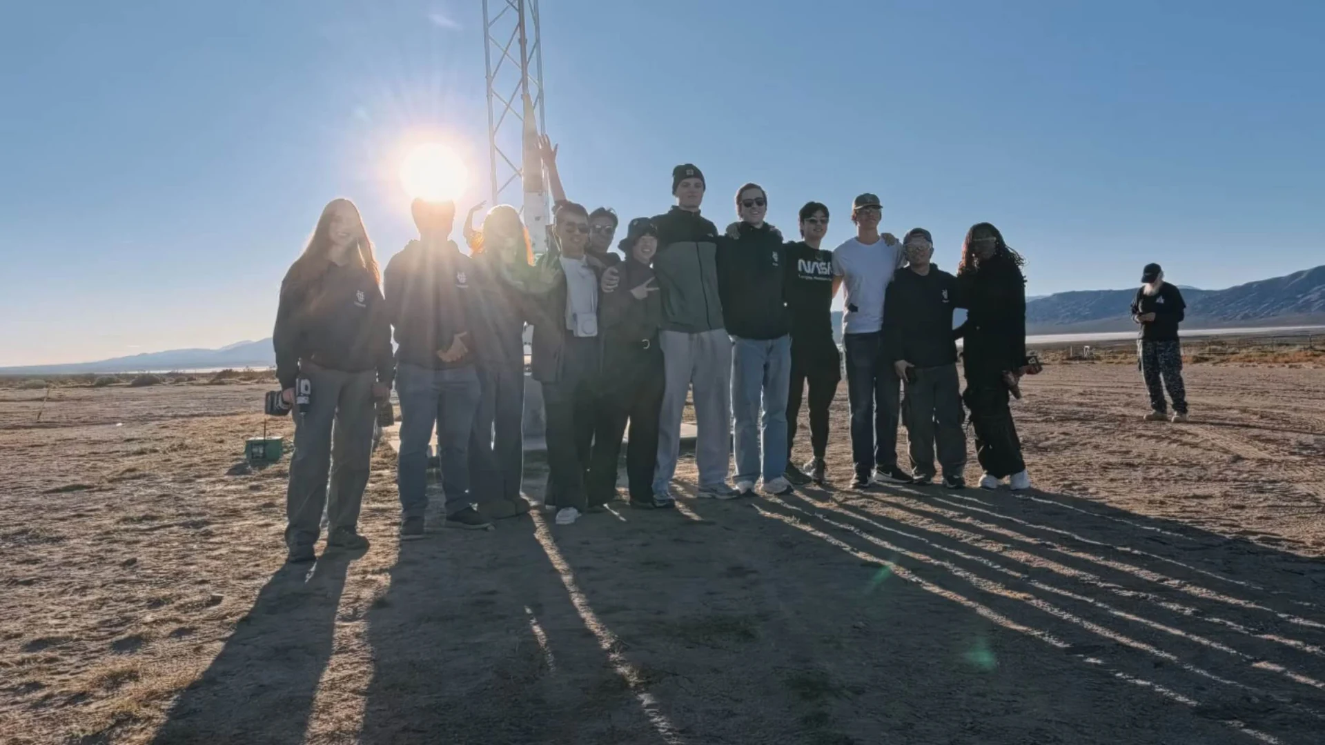 The Launch Vehicle team standing together beside the tower at FAR